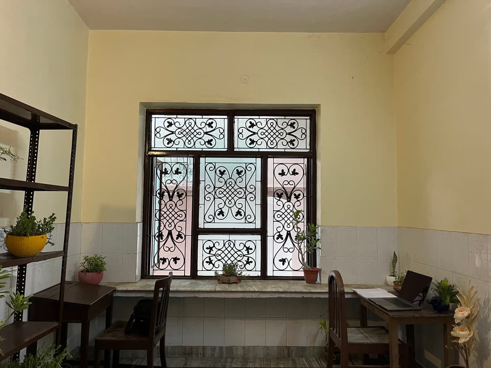 Large grilled window with study surfaces on both sides.