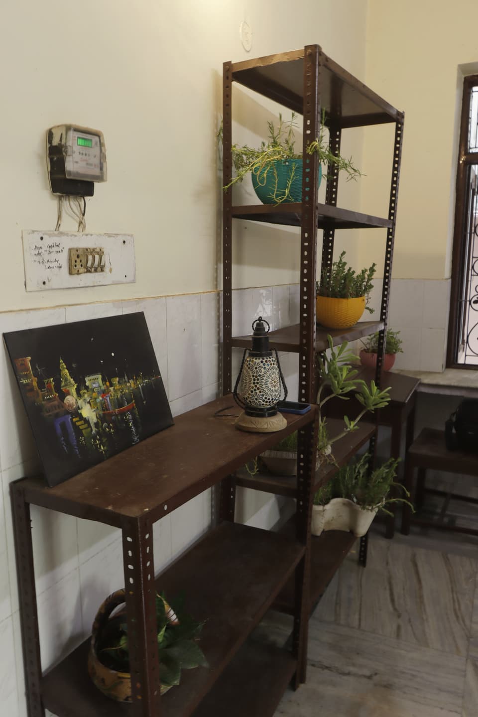 Study table and open shelving inside the bright room.