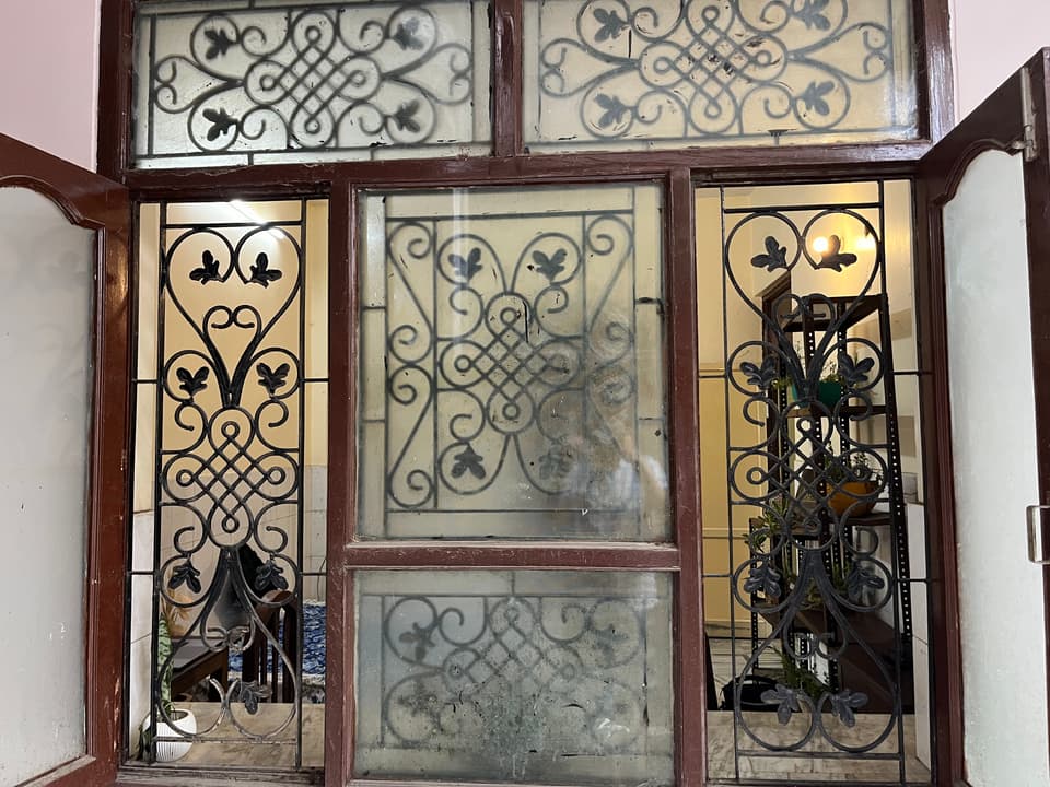 Large grilled window viewed from outside the room.