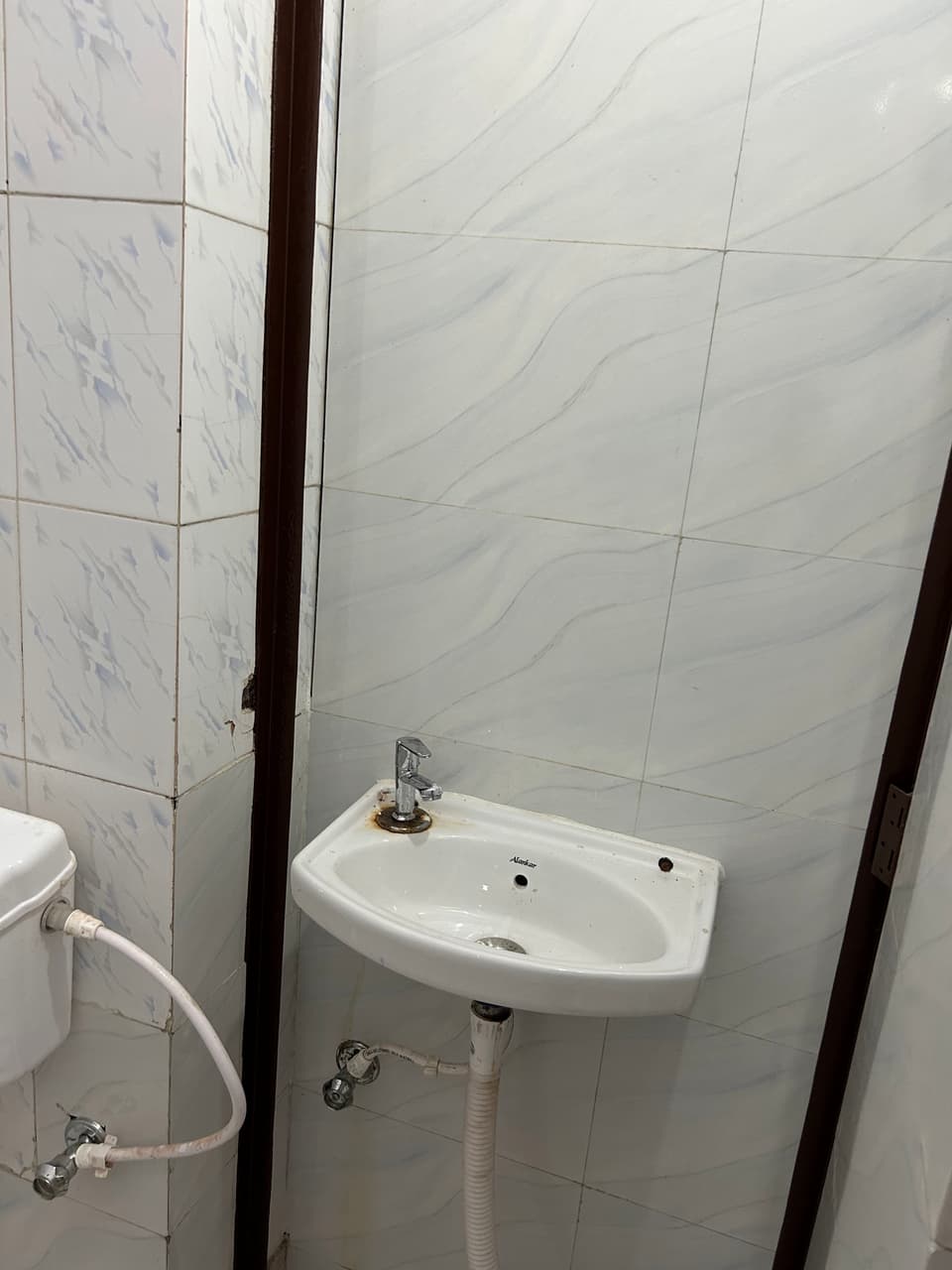 Single room angle showing the sleeping area and study table.