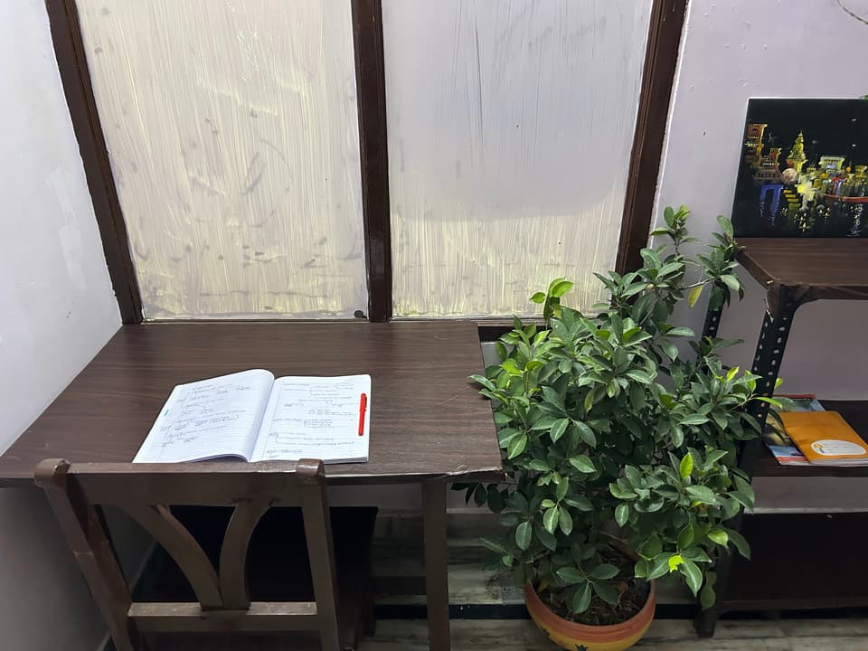 Study table beneath the garden-facing window.