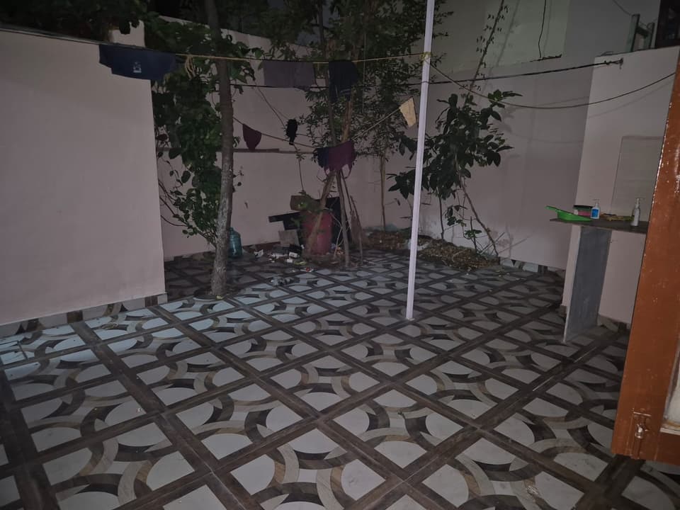Shared utility courtyard with a clothes line and washing area.