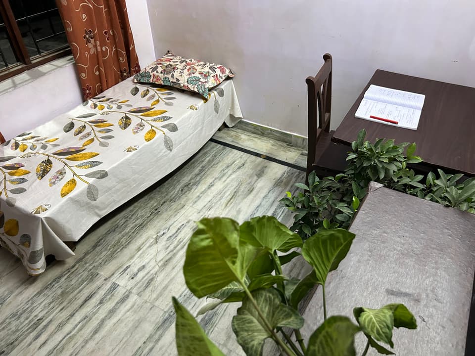 Bed-side angle inside the garden-facing solo room.