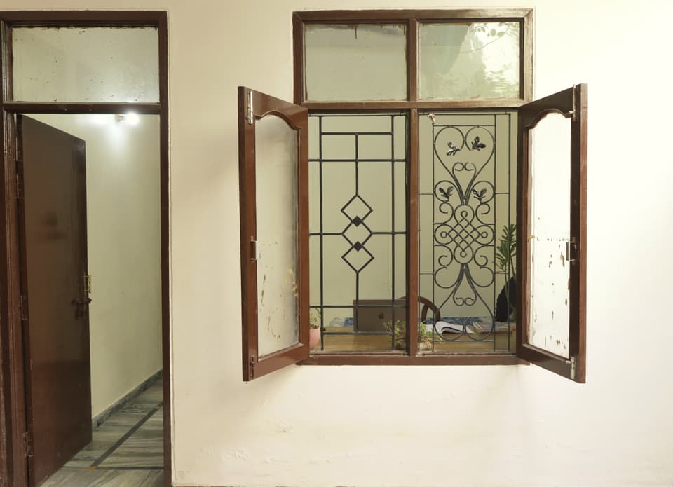 Open courtyard window and the room entrance.