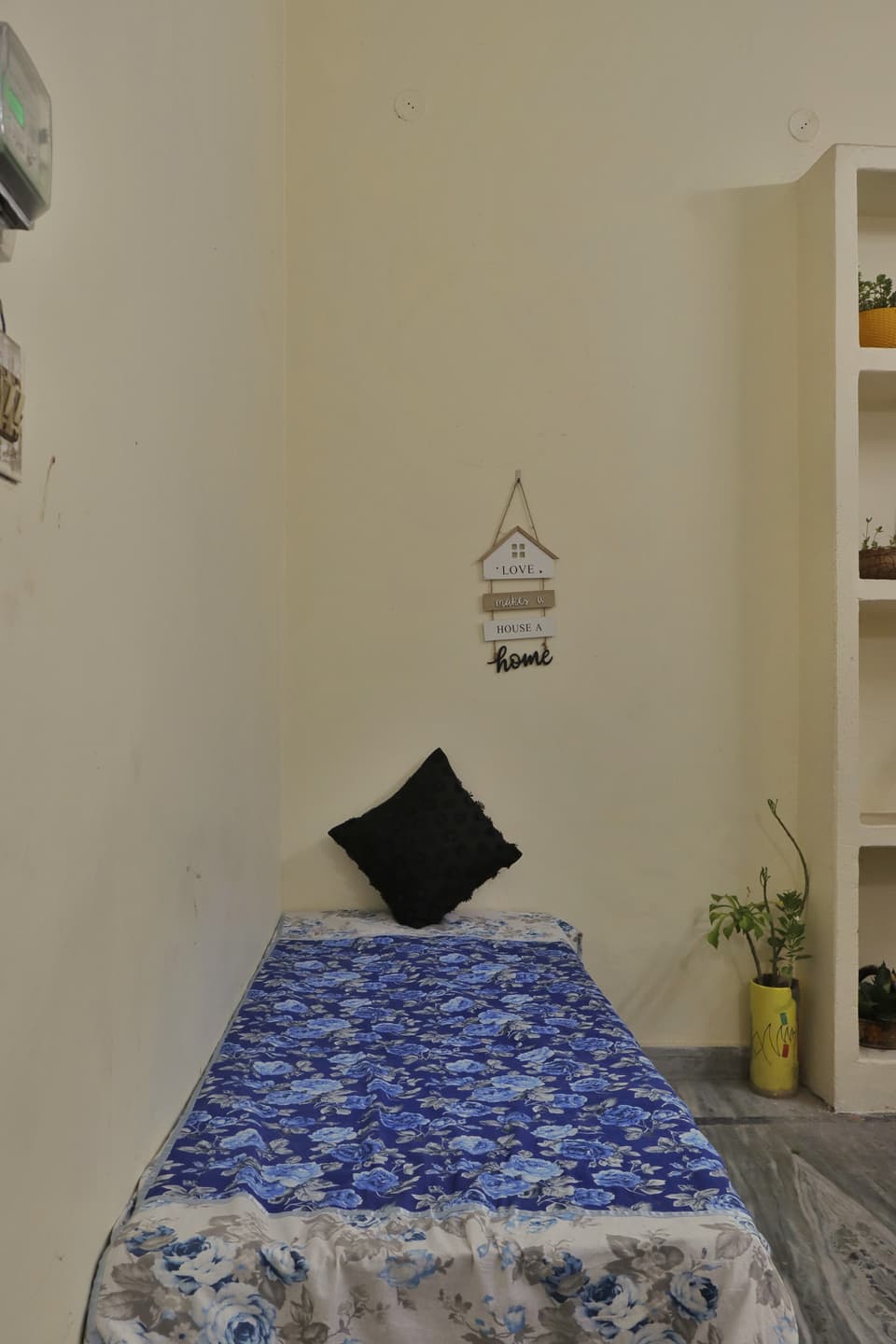Single bed along the wall of the courtyard-side room.