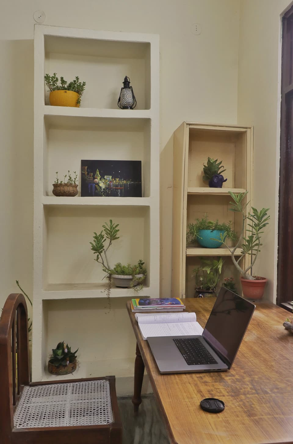 Study desk and built-in wall shelves inside the room.