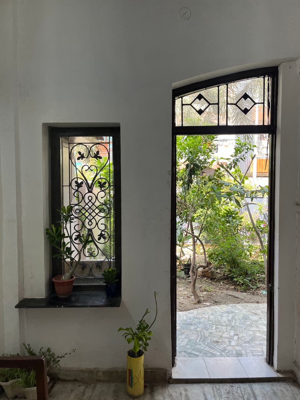 Garden-side doorway and window at the room entrance.