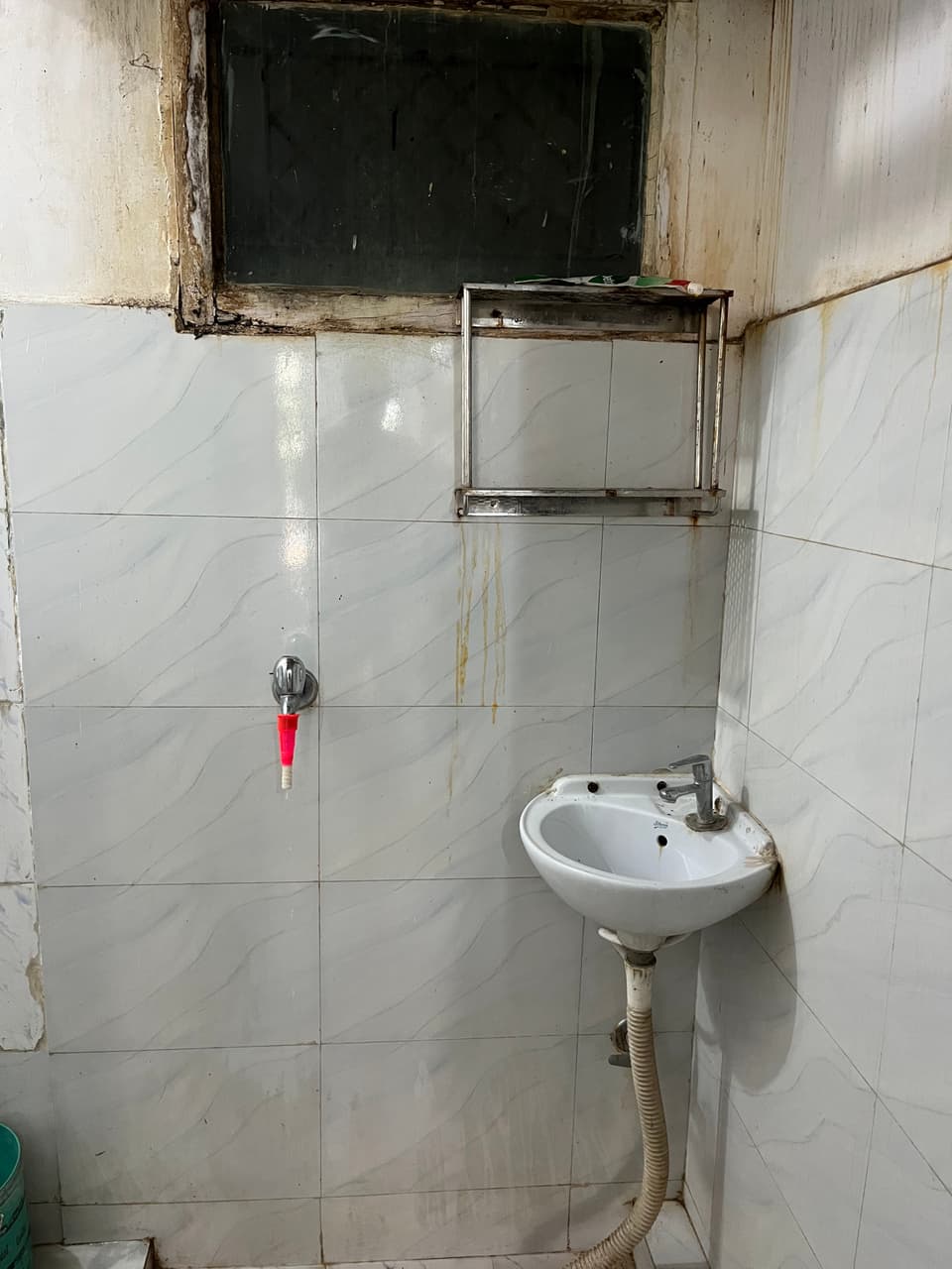 Wall-mounted basin inside the attached washroom.