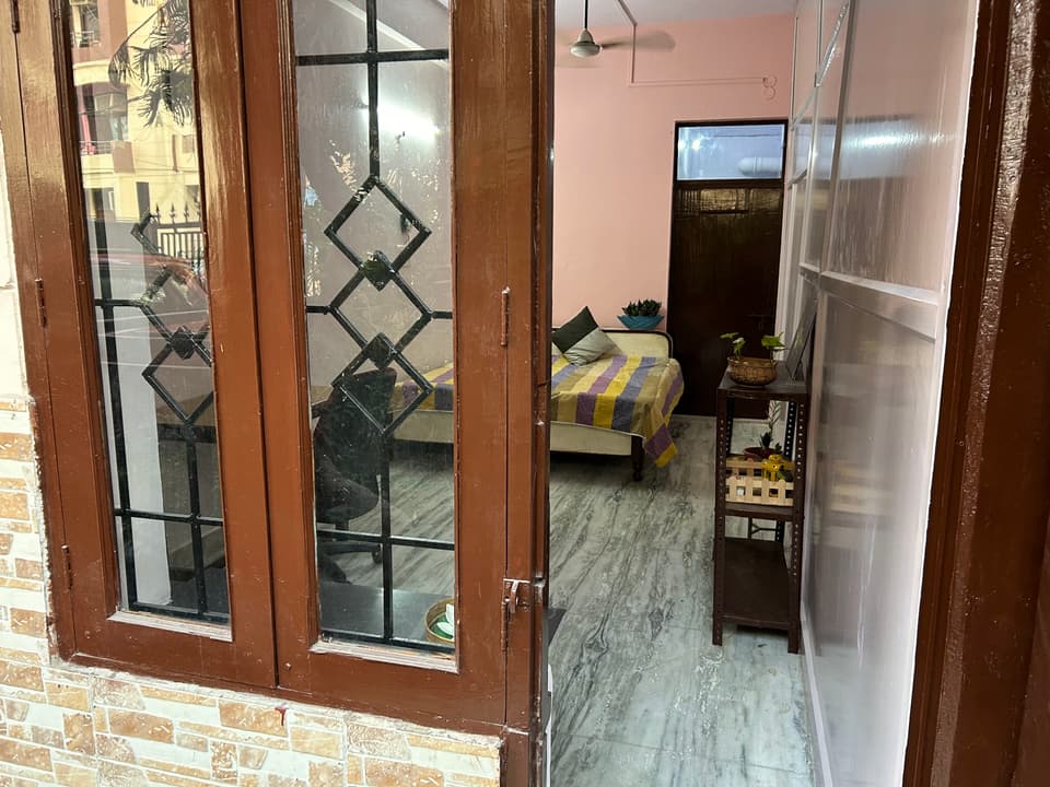 Desk and bed arrangement inside the garden-view studio.