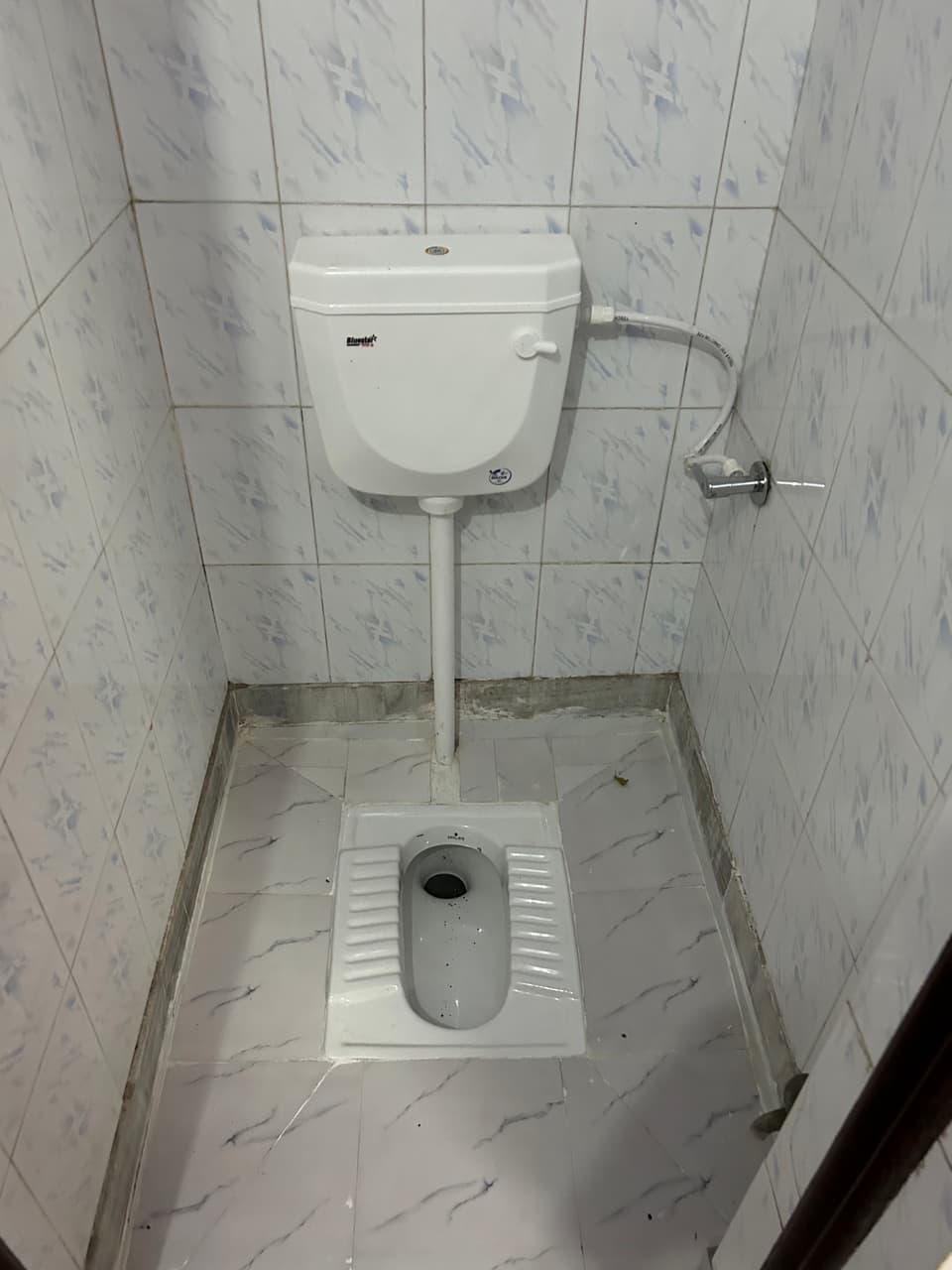 Bed-side perspective inside the garden-view studio.