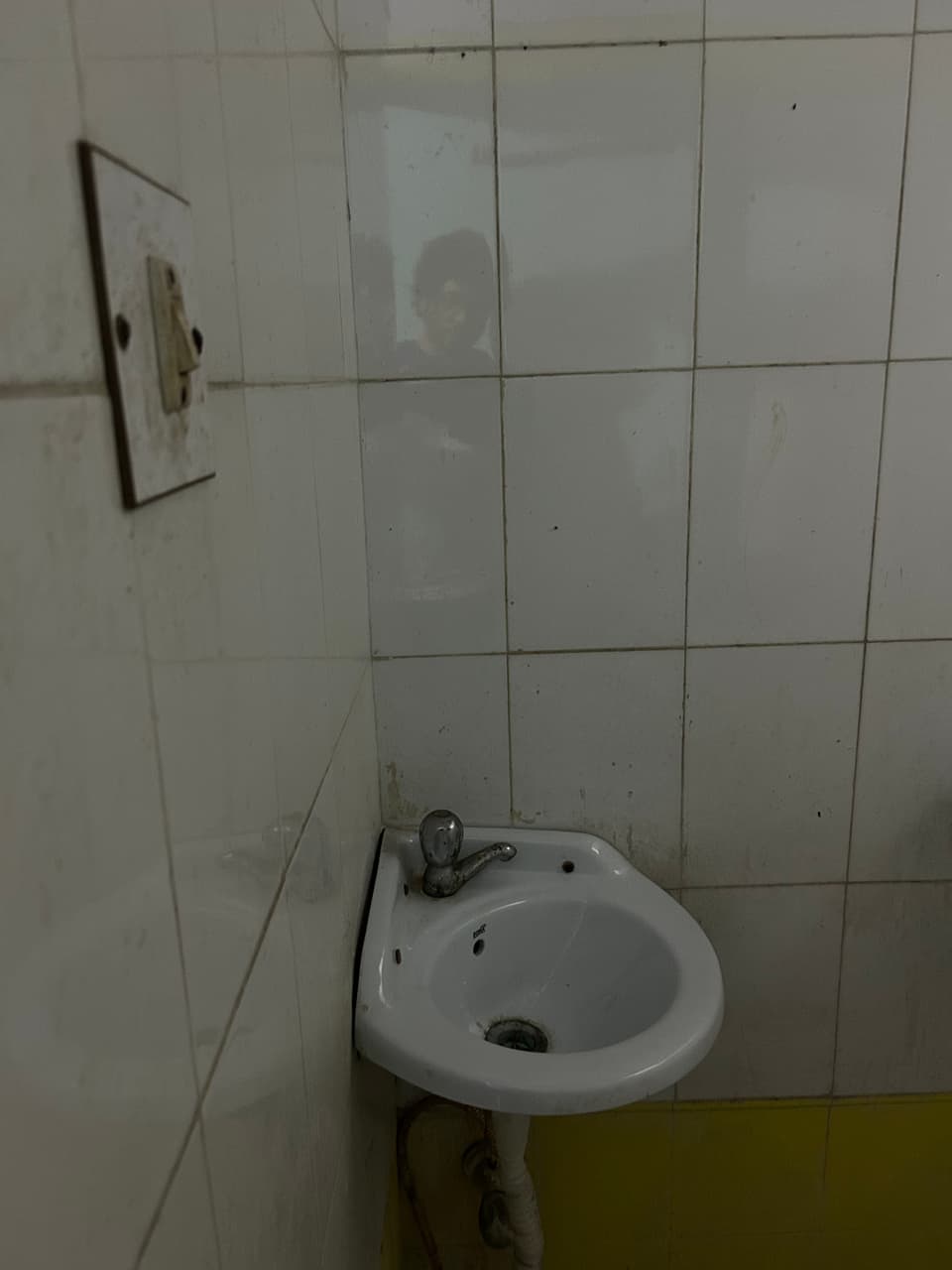 Wall-mounted basin inside the attached washroom.