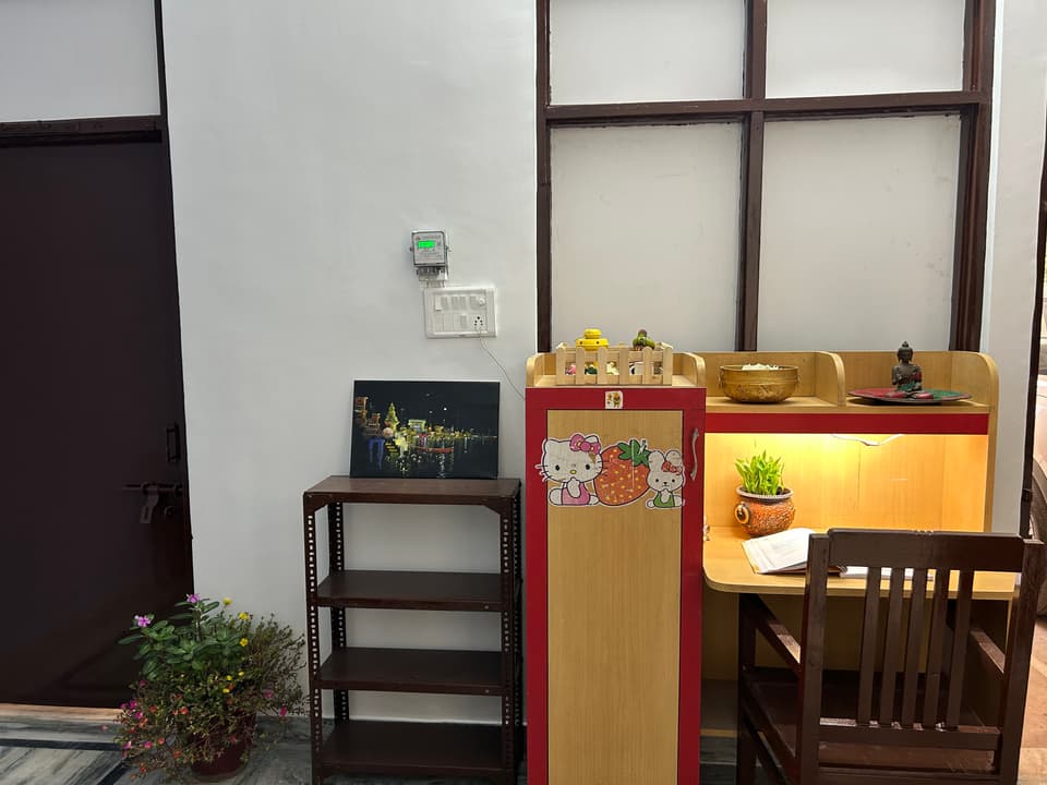 Study table, chair, storage unit, and open shelves.
