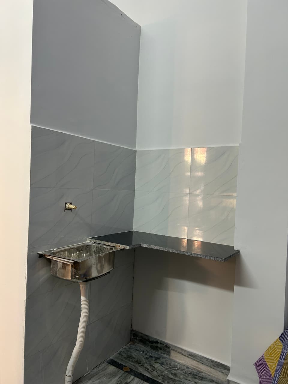 Another angle of the studio showing bed placement and circulation space.